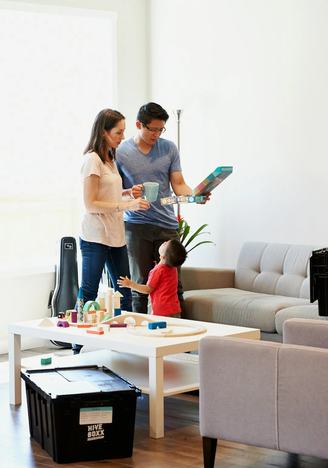 Spacious and contemporary office interior with glass partitions, stylish furniture, and vibrant wall art.